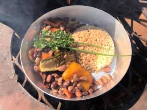 Traditional Zimbabwe food cooked on fire. Peanut butter rice, sugar beans, butternut, Dusty Road township experience in Victoria Falls, ZImbabwe