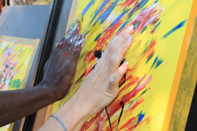 Finger painting on an Art of Africa cultural tour in Victoria Falls