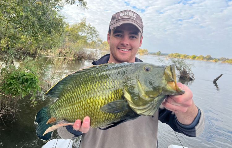 Fishing on a boat above the Victoria Falls, Zimbabawe