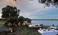 Relaxing on a canoe safari on the Zambezi River, upstream from the Victoria Falls, Zimbabwe