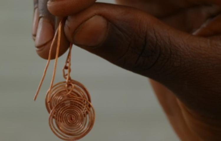 Repurposed copper earring made from snare wire which was collected by anti-poaching efforts in Souther Africa