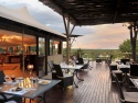 Dine in the cool shade with a view of the bush