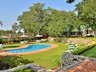 The pool and garden at Batonka Guest Lodge