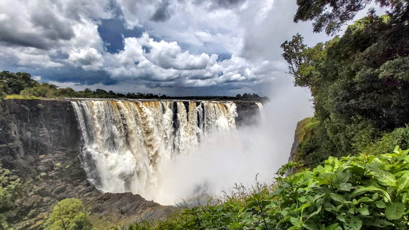 Victoria Falls in good flood with storm clouds above