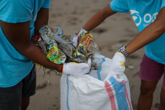 Plastic and other litter being taken away from a beach