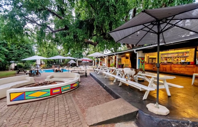 The fire pit and swimming pool in the background